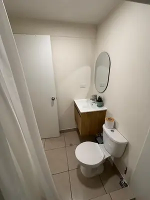a bathroom with a white toilet and a sink at Amplia habitación con baño propio a 20 min del aeropuerto in Lima