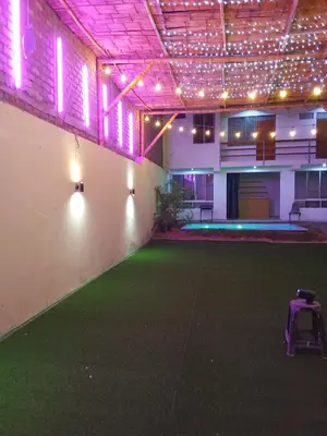 a large room with a green floor and lights at Excellent house in Quilmana in Quilmaná