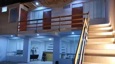 a spiral staircase in a building with a desk at Excellent house in Quilmana in Quilmaná