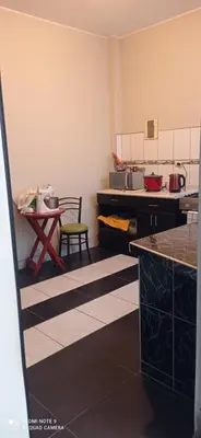 a kitchen with a table and a chair in it at CHANCAY 1er Piso Como en Casa in Chancay