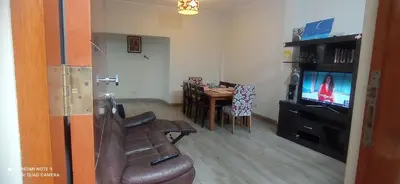 a living room with a couch and a table and a television at CHANCAY 1er Piso Como en Casa in Chancay