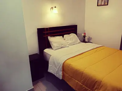a bedroom with a large bed with yellow sheets and pillows at Destinos Peru Inn - Destinos in Machu Picchu