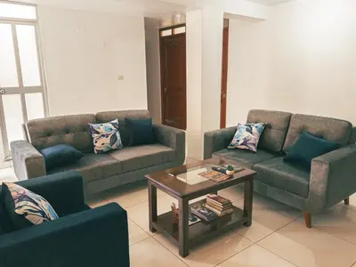 a living room with two couches and a coffee table at Departamento en Ayacucho in Ayacucho