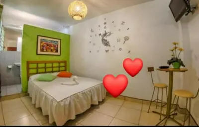 a bedroom with two red hearts on the wall at Inka Palace Resort in Santa Eulalia