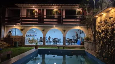 a house with a swimming pool and a patio at Inka Palace Resort in Santa Eulalia
