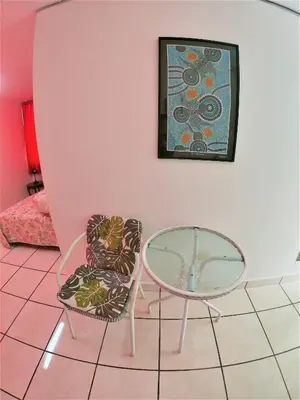 a room with a table and a chair and a picture at Waves Surf Camp Peru in Punta Hermosa