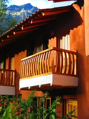 a balcony on the side of a building at Birds Hotel Molino in Ollantaytambo
