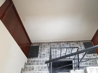 a staircase in a house with a brick wall at Lima Flats in Lima