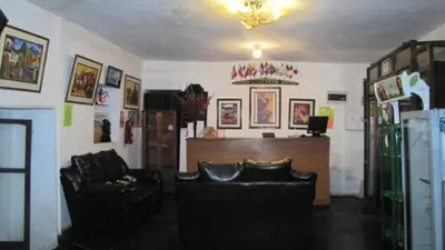 a living room with two leather chairs and a desk at Hostel Imperial BACKPACKER in Cusco