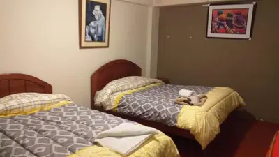 two beds sitting next to each other in a bedroom at Hostel Imperial BACKPACKER in Cusco