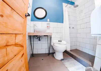 a bathroom with a toilet and a sink at Supertramp Hostel Cusco in Cusco