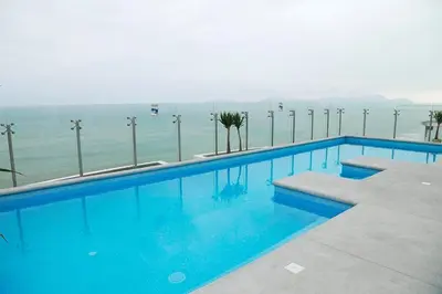 a swimming pool with the ocean in the background at Lima Flats 2 in Lima