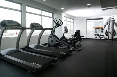 a gym with three tread machines in a room at Lima Flats 2 in Lima