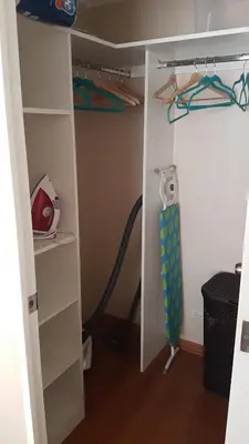 a room with a closet with a shelf and a treadmill at Lima Flats 2 in Lima