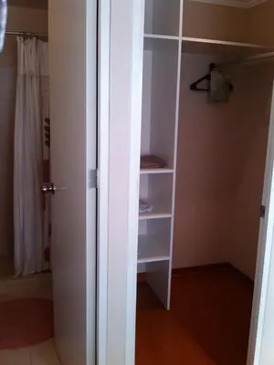 a white closet with a door open to a room at Lima Flats 2 in Lima