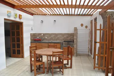a kitchen with a table and chairs in a room at Bujama Campo Mar in Bujama Baja