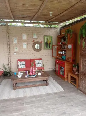 a living room with a couch and a table at Bujama Campo Mar in Bujama Baja
