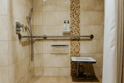 a shower stall with a table in a bathroom at Hilton Garden Inn Cusco in Cusco
