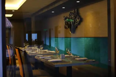a long table in a restaurant with a clock on the wall at Hilton Garden Inn Cusco in Cusco