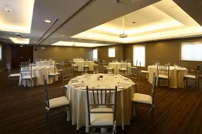 a banquet room with tables and chairs with white tablecloths at Hilton Garden Inn Cusco in Cusco