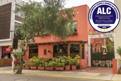 a pink building with a sign in front of it at El Patio Miraflores in Lima