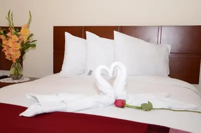 a bed with two swans made out of towels at Aqua Hotel Cusco in Cusco