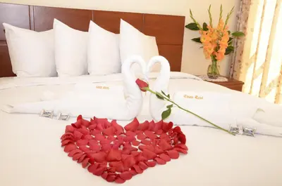 a bed with two swans and a heart of roses at Aqua Hotel Cusco in Cusco