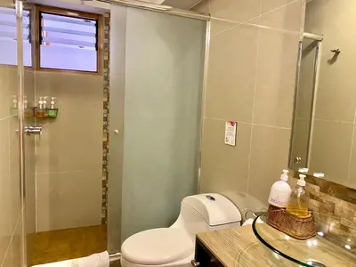a bathroom with a toilet and a glass shower at Mistico San Blas Boutique in Cusco