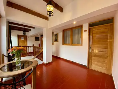 a hallway with a table and a wooden door at Mistico San Blas Boutique in Cusco