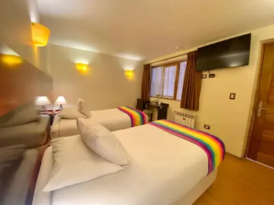 a hotel room with two beds and a couch at Mistico San Blas Boutique in Cusco