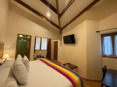 a bedroom with a rainbow blanket on a bed at Mistico San Blas Boutique in Cusco