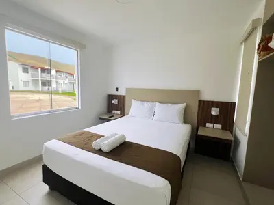 a bedroom with a large white bed with a window at DM Hoteles Asia in Asia