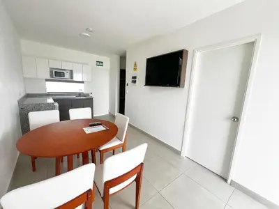 a kitchen and dining room with a table and chairs at DM Hoteles Asia in Asia