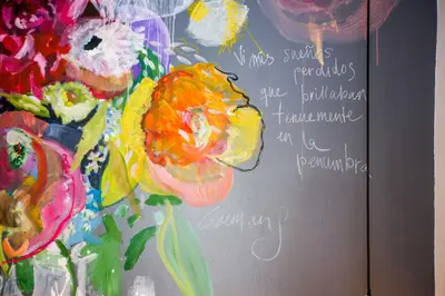 a painting of a vase of flowers on a wall at Niños Hotel Meloc in Cusco
