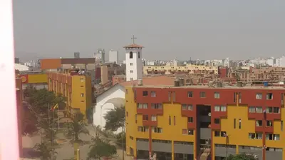 a view of a city with buildings and a lighthouse at Cozy Room - Margot Arimborgo in Lima