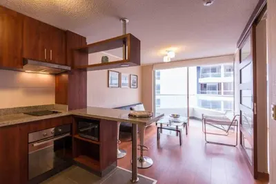 a kitchen with a counter and a table in a room at Ocean View Beautiful Aparment in Lima