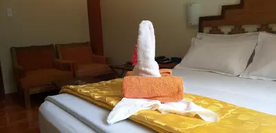 a hotel room with a bed with towels on it at Hostal Vista Waynapata 123 in Machu Picchu