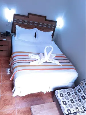 a bedroom with a bed with two towels on it at Hostal Vista Waynapata 123 in Machu Picchu
