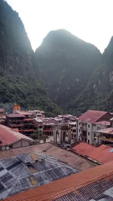 a group of buildings in front of a mountain at Hostal Vista Waynapata 123 in Machu Picchu