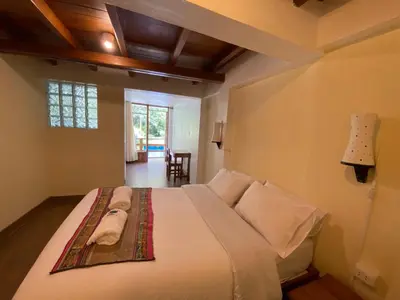a bedroom with a large bed in a room at Mistico Machupicchu Eco B&B in Machu Picchu