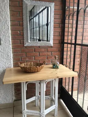 a table with a mirror and a basket on it at Bungalows Cerro Azul in Cerro Azul