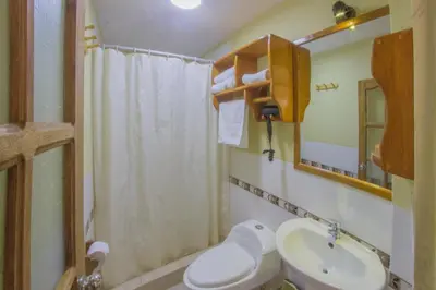 a small bathroom with a toilet and a sink at Parwa Guest House in Ollantaytambo