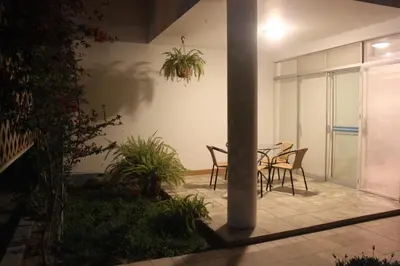 a patio with chairs and a table in a building at Caihuayna Apart Hotel in Paracas