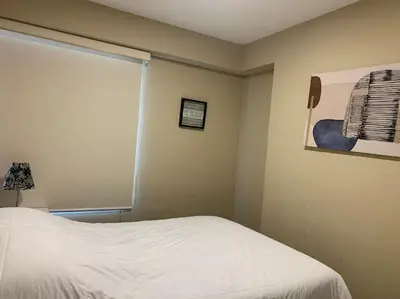 a bedroom with a white bed and a window at MLA apartments - Kennedy in Lima