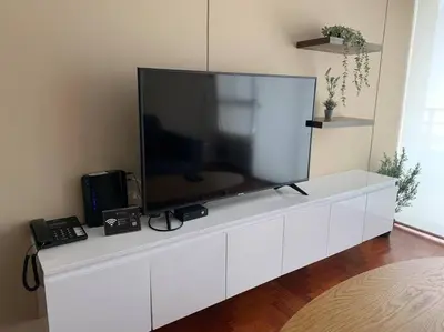 a television on a white cabinet in a living room at MLA apartments - Kennedy in Lima