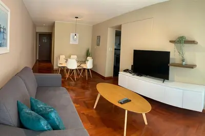 a living room with a couch and a flat screen tv at MLA apartments - Kennedy in Lima