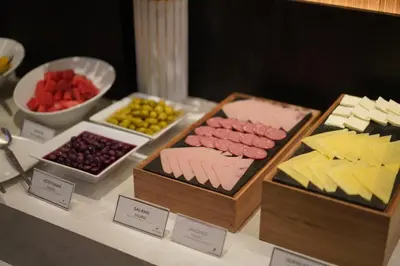 a buffet of different types of cheese and other foods at Hotel Ferré Miraflores in Lima