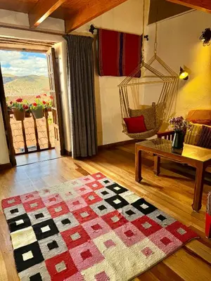a living room with a swing and a rug at ARQUEOLOGO Exclusive Boutique Hotel Cusco - Centro Histórico in Cusco
