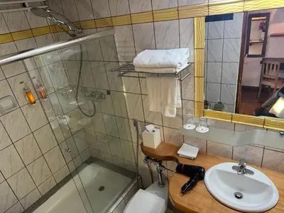 a bathroom with a sink and a shower and a toilet at ARQUEOLOGO Exclusive Boutique Hotel Cusco - Centro Histórico in Cusco