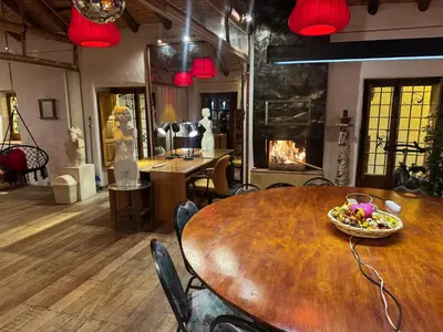 a dining room with a table and a fireplace at ARQUEOLOGO Exclusive Boutique Hotel Cusco - Centro Histórico in Cusco